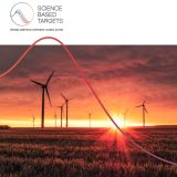 The image features a landscape with wind turbines against a striking sunset sky. The foreground shows a field, likely of crops, with the warm glow of the sun casting long shadows. A graphic overlay with a red curve divides the image diagonally, and above this, the logo and text 